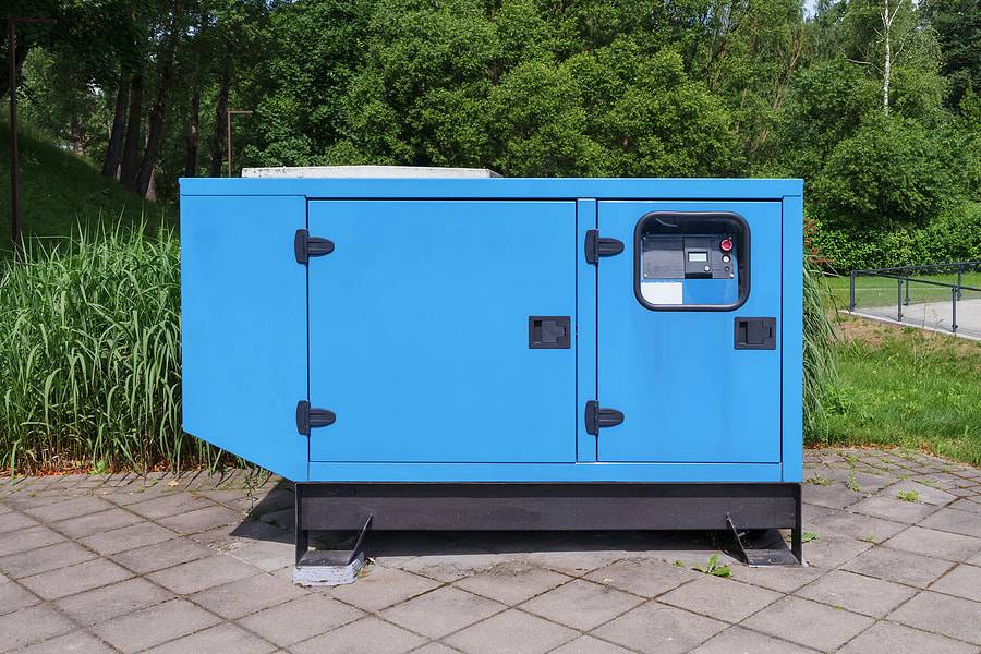 a blue portable generator sitting on top of a sidewalk